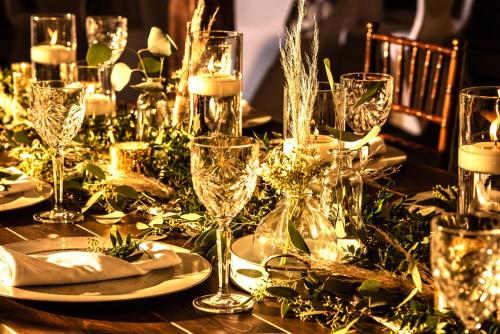 a table with a christmas centerpiece with wine glasses at Christmas Farm Inn and Spa in Jackson