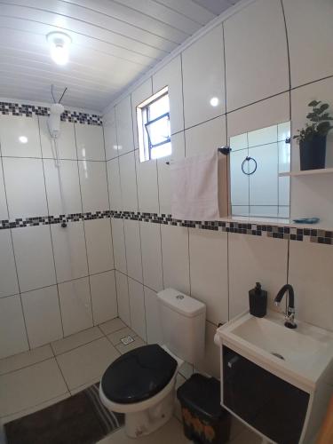 a bathroom with a toilet and a sink at Hotel cabanas bom Jesus in Ametista do Sul