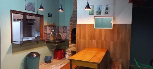 a kitchen with a wooden table in a room at Casa Serrana beach Camocim in Camocim