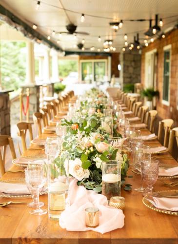 a long table with glasses and flowers on it at The Inn at Thorn Hill in Jackson