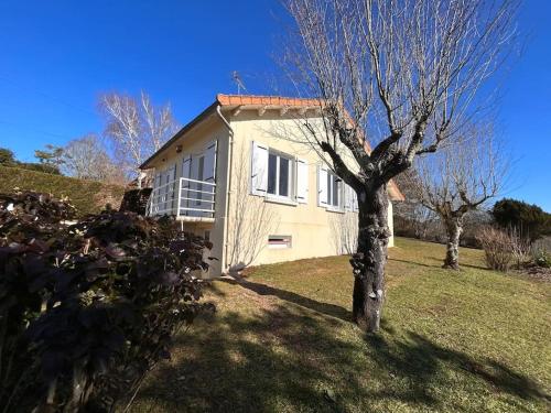a white house with a tree in the yard at Maison au coeur du Périgord Vert in Javerlhac-et-la-Chapelle-Saint-Robert