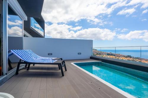 a balcony with a swimming pool on a building at Tiz house in Funchal
