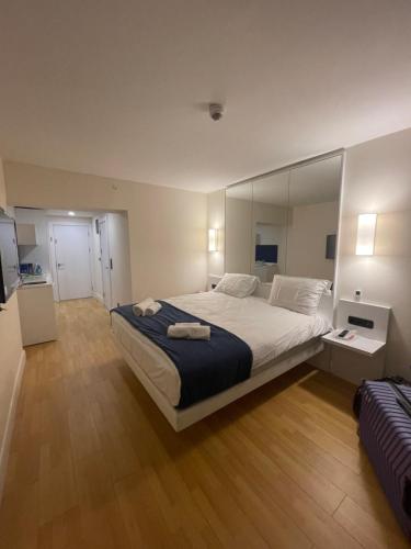 a bedroom with a large bed with a large mirror at Orbi Sea view Blok D in Batumi