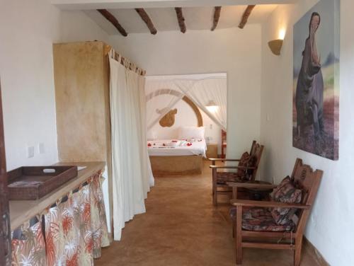 a hallway leading to a bedroom with a bed at Boutique Hotel Nyumbani Tembo in Watamu