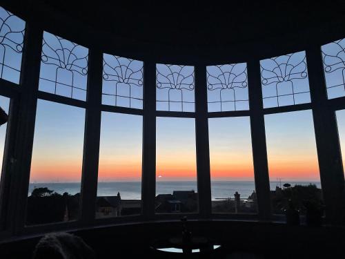 a window with a view of the ocean seen through it at 1 Bedroom Sea side luxury in New Brighton