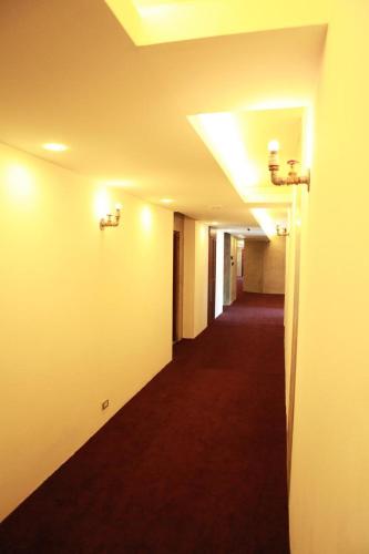an empty hallway in a building with a red carpet at S Park Design Hotel in Vientiane