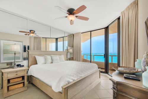 a bedroom with a bed with a view of the ocean at East Pass 309 in Destin
