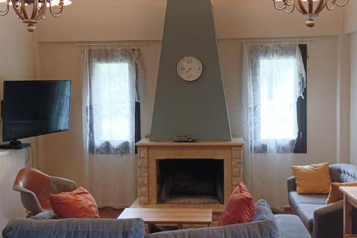 uma sala de estar com lareira e televisão em Αναστασία 