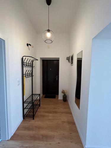 a hallway with white walls and a black door at Nina & Lola in Rijeka