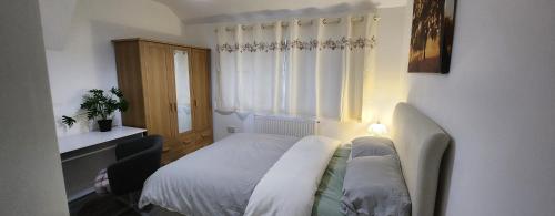 a small bedroom with a bed and a window at White House Ensuite double bedroom in Warrington