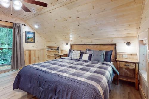 a bedroom with a bed in a log cabin at Up the Creek in Gatlinburg