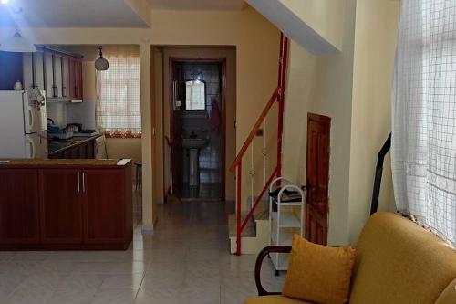a kitchen and a living room with a couch and a kitchen at Altınoluk ta deniz ve doğa manzaralı 3 oda salon in Edremit