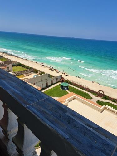 a view of a beach and the ocean from a bridge at Panorama Apartment with a charming sea view near Alexandria and Burg ElArab Airport with Free Wifi شقة باطلالة ساحرة على البحر اول الساحل الشمالي واي فاي مجاني迷人海景公寓 免费无线网络 in Alexandria