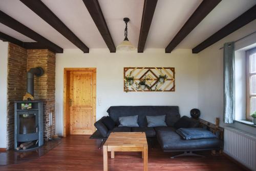 a living room with a couch and a table at Landhaus Charlotte - Feldblick in Wassersuppe