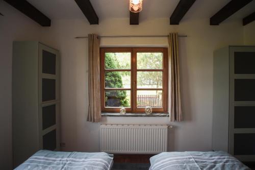 a bedroom with two beds and a window at Landhaus Charlotte - Feldblick in Wassersuppe