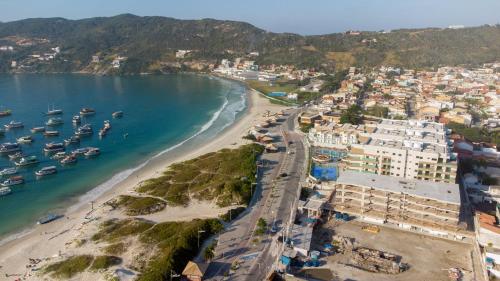 an aerial view of a beach with boats in the water at Arraial Praia Ap - Residence Club Praia dos Anjos in Arraial do Cabo