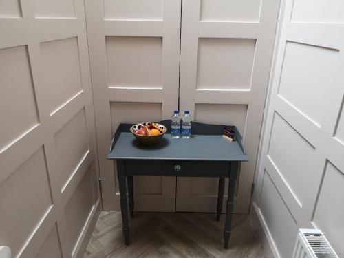 a small table in a room with a bowl of fruit at Stylish studio own entrance in Victorian House in Dublin