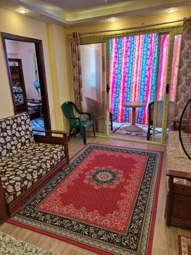 a living room with a couch and a rug at Panorama Apartment with a charming sea view near Alexandria and Burg ElArab Airport with Free Wifi شقة باطلالة ساحرة على البحر اول الساحل الشمالي واي فاي مجاني迷人海景公寓 免费无线网络 in Alexandria