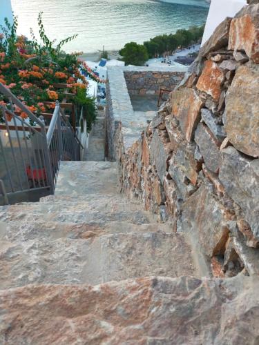 a stone stairway leading down to the beach at Amorgos Elegant Houses, 6 Villas in Amorgos