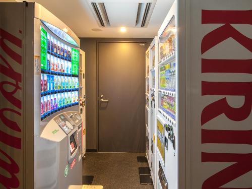 a convenience store aisle with a soda machine at Hakata Green Hotel Annex in Fukuoka