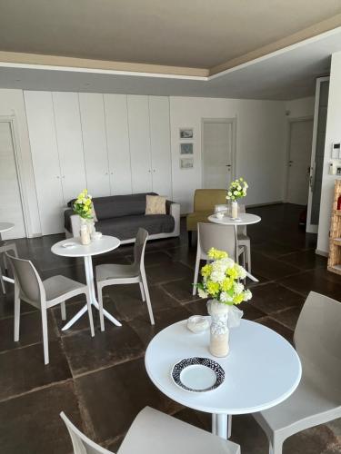 a living room with tables and chairs and a couch at Percebes Exclusive B&B in Cutrofiano