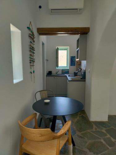 a small kitchen with a table and chairs in a room at Amorgos Elegant Houses, 6 Villas in Amorgos