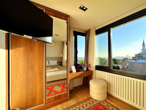 a room with a bed and a large window at Sultan Pier Hotel in Istanbul