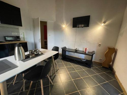 a kitchen with a counter and chairs in a room at Andapamanitra Résidence in Antananarivo