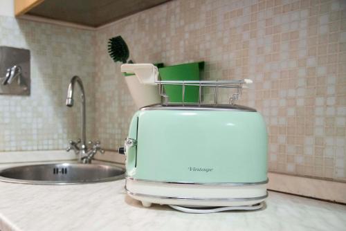 a toaster sitting on a counter next to a sink at Garden House in Rome