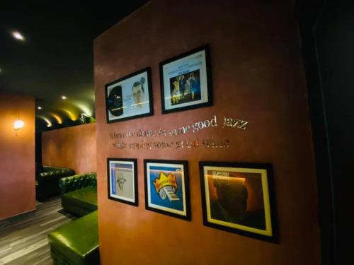 a wall with pictures on it in a room at Chu Hotel in Da Nang