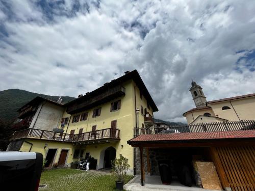 a large building with a clock tower on top of it at Appartamenti Casa Miravalle in Enguiso