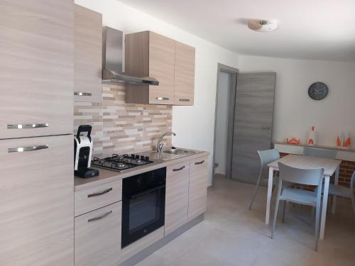 a kitchen with a sink and a stove top oven at Appartamento La Dama in Scilla