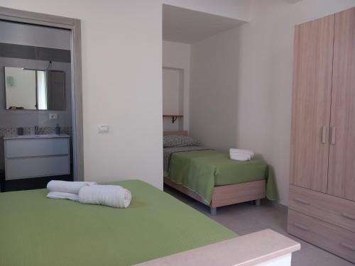 - une petite chambre avec un lit et une salle de bains dans l'établissement Appartamento La Dama, à Scilla