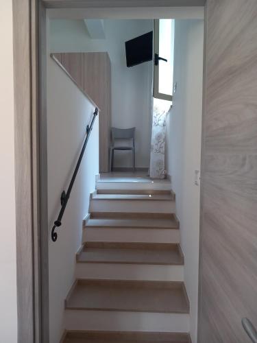 a stairway with a chair and a stair case at Appartamento La Dama in Scilla