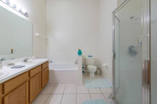 a bathroom with a shower and a sink and a toilet at Orlando getaway in Orlando