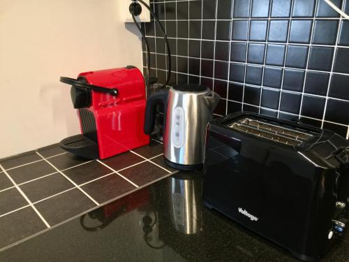 a counter with a coffee maker and a toaster on it at Bäckalyckan in Röstånga