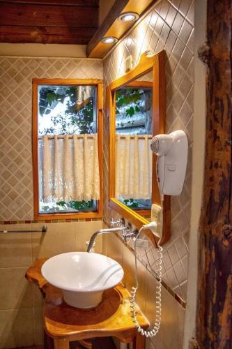 a bathroom with a sink and a blow dryer at Piedramora in Villa Giardino
