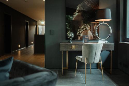 a room with a desk with a mirror and a chair at Sellmann´s Boutique Hotel in Dortmund