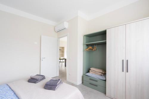a bedroom with a bed and a closet at Borgo alla Pieve Apartments by Garda Facilities in Manerba del Garda