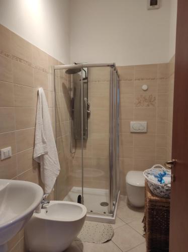 a bathroom with a shower and a sink and a toilet at Casa Lore in Livorno