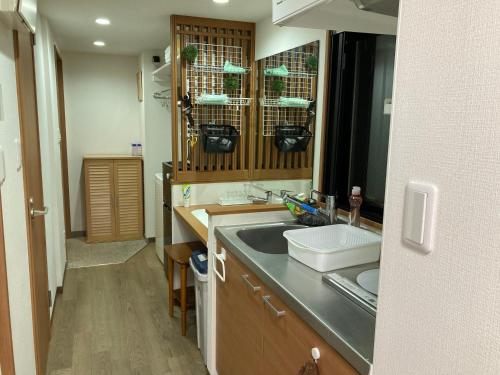 a kitchen with a sink and a counter top at 安ホテルサンシャイン in Tokyo