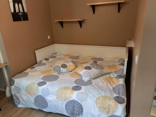 a bedroom with a bed with a comforter and pillows at Chaillot 6 in Saintes