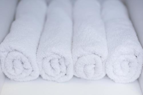 a row of white towels on a shelf at Apartment Tonka-Riva in Split