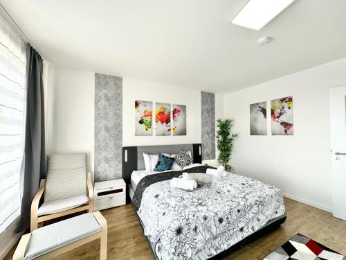 a bedroom with a bed and a chair at Design apartment Dresden centre - enjoy and relax in Dresden