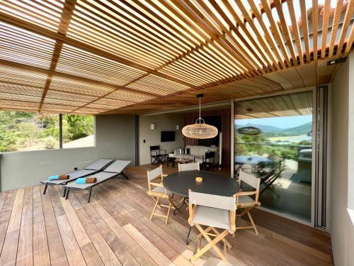 a dining room with a table and chairs on a wooden floor at Domaine Santa Giulia Palace in Porto-Vecchio