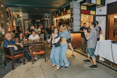 a group of people standing in a restaurant at Chu Hotel in Da Nang