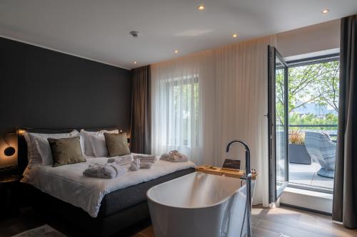 a bedroom with a large bed and a bath tub at Sellmann´s Boutique Hotel in Dortmund