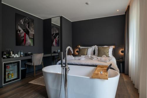 a bedroom with a bath tub and a bed at Sellmann´s Boutique Hotel in Dortmund