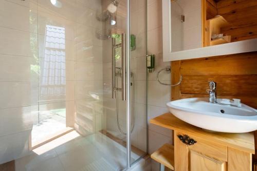 a bathroom with a sink and a shower at Forest Amerika-Bungalovi Milica in Vrbovsko