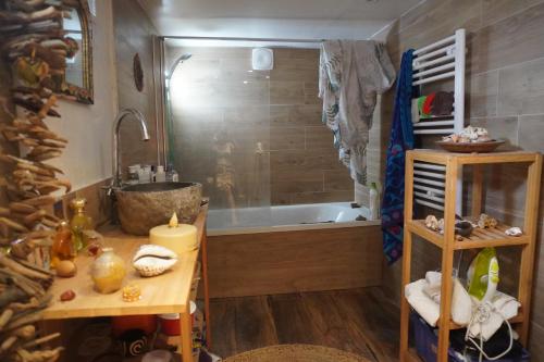 La salle de bains est pourvue d'une baignoire et d'une table en bois. dans l'établissement Loft cosy et lumineux à Paris,Les Lilas dans un quartier convivial proche du métro 11 